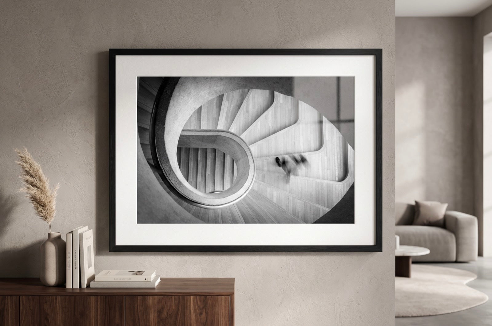 A framed fine art print hung above a sideboard