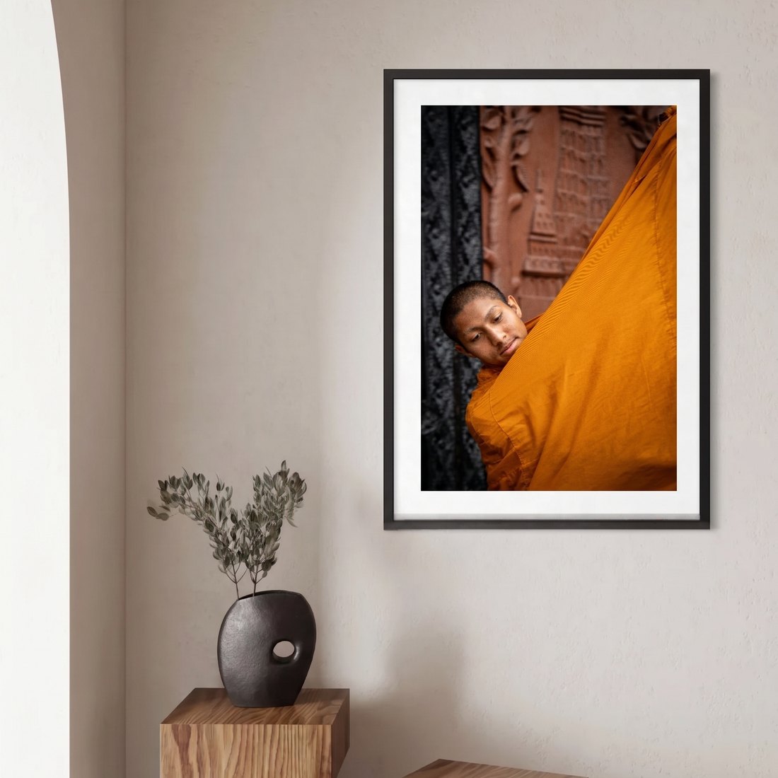 A framed print in a slim black frame with a wide white mat, hung on a plain wall